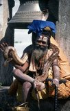 They are known, variously, as sadhus (saints, or 'good ones'), yogis (ascetic practitioners), fakirs (ascetic seeker after the Truth) and sannyasins (wandering mendicants and ascetics). They are the ascetic – and often eccentric – practitioners of an austere form of Hinduism. Sworn to cast off earthly desires, some choose to live as anchorites in the wilderness. Others are of a less retiring disposition, especially in the towns and temples of Nepal's Kathmandu Valley.<br/><br/>

If the Vale of Kathmandu seems to boast more than its share of sadhus and yogis, this is because of the number and importance of Hindu temples in the region. The most important temple of Vishnu in the valley is Changunarayan, and here the visitor will find many Vaishnavite ascetics. Likewise, the most important temple for followers of Shiva is the temple at Pashupatinath.<br/><br/>

Vishnu, also known as Narayan, can be identified by his four arms holding a sanka (sea shell), a chakra (round weapon), a gada (stick-like weapon) and a padma (lotus flower). The best-known incarnation of Vishnu is Krishna, and his animal is the mythical Garuda.<br/><br/>

Shiva is often represented by the lingam, or phallus, as a symbol of his creative side. His animal is the bull, Nandi, and his weapon is the trisul, or trident. According to Hindu mythology Shiva is supposed to live in the Himalayas and wears a garland of snakes. He is also said to smoke a lot of bhang, or hashish.